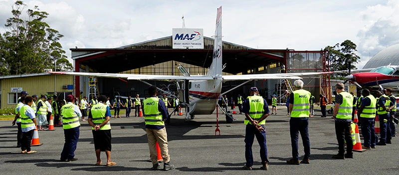 MAF staff perform a circle around P2-AFD in prayer